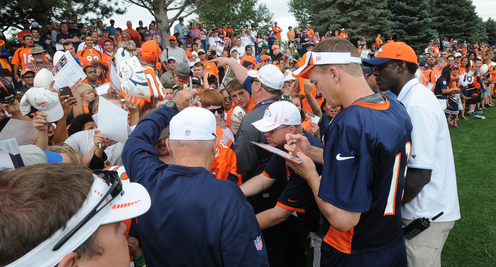 Denver Broncos quarterback Peyton Manning signs autographs for the fans. The Denver Broncos took to the field for the first day of training camp at Dove Valley on Thursday, July 25, 2013. (Jerilee Bennett/The Gazette)